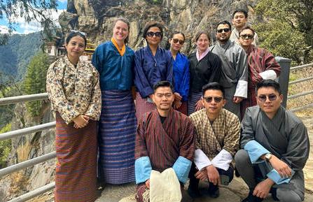 Doctors pose along mountainside in traditional Bhutanese garb